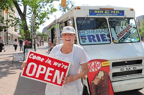 RUTH BONNEVILLE / WINNIPEG FREE PRESS

49.8 - Sis & Me food truck

Joyce & Garry Powers, Sis & Me food truck, parked at Broadway & Edmonton.  

Fun photo of Joyce holding her open sign in front of her food truck.

Story: This is for an Intersection piece on Sis & Me, a food truck celebrating its 25th anniversary on the streets of Winnipeg. Owners Joyce & Garry were one of two food trucks on Broadway when they started - mostly hot dog carts back then. They've been going strong ever since, and now that they're allowed back on the street - their license was delayed 'til May 1 this year owing to COVID - their reg customers are welcoming them back with open arms.


Story is due to run Sat June 20 - Dave Sanderson story,. 

June 16,  2020
