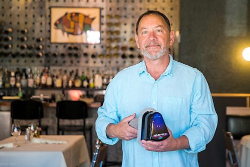 MIKAELA MACKENZIE / WINNIPEG FREE PRESS

Scot McTaggart, owner of Fusion Grill, shows off the air filtering device (which will be installed into his ventilation system) in his restaurant in Winnipeg on Friday, June 19, 2020.  Studies are going on to see if the system will kill COVID-19. For Gabrielle Piche story.
Winnipeg Free Press 2020.