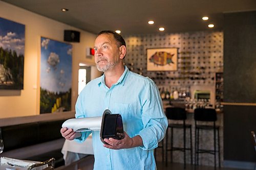 MIKAELA MACKENZIE / WINNIPEG FREE PRESS

Scot McTaggart, owner of Fusion Grill, shows off the air filtering device (which will be installed into his ventilation system) in his restaurant in Winnipeg on Friday, June 19, 2020.  Studies are going on to see if the system will kill COVID-19. For Gabrielle Piche story.
Winnipeg Free Press 2020.