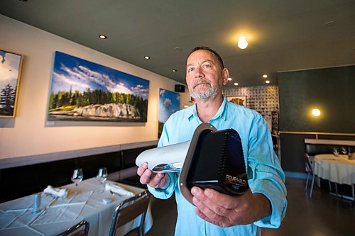 MIKAELA MACKENZIE / WINNIPEG FREE PRESS

Scot McTaggart, owner of Fusion Grill, shows off the air filtering device (which will be installed into his ventilation system) in his restaurant in Winnipeg on Friday, June 19, 2020.  Studies are going on to see if the system will kill COVID-19. For Gabrielle Piche story.
Winnipeg Free Press 2020.