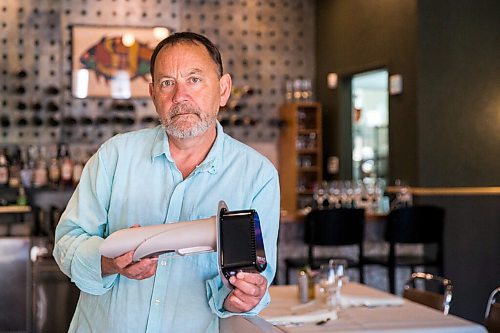 MIKAELA MACKENZIE / WINNIPEG FREE PRESS

Scot McTaggart, owner of Fusion Grill, shows off the air filtering device (which will be installed into his ventilation system) in his restaurant in Winnipeg on Friday, June 19, 2020.  Studies are going on to see if the system will kill COVID-19. For Gabrielle Piche story.
Winnipeg Free Press 2020.