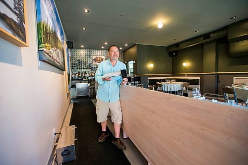 MIKAELA MACKENZIE / WINNIPEG FREE PRESS

Scot McTaggart, owner of Fusion Grill, shows off the air filtering device (which will be installed into his ventilation system) in his restaurant in Winnipeg on Friday, June 19, 2020.  The silver box on the ground is a temporary air filter. Studies are going on to see if the system will kill COVID-19. For Gabrielle Piche story.
Winnipeg Free Press 2020.