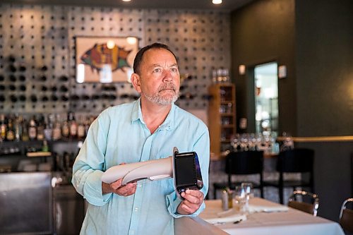 MIKAELA MACKENZIE / WINNIPEG FREE PRESS

Scot McTaggart, owner of Fusion Grill, shows off the air filtering device (which will be installed into his ventilation system) in his restaurant in Winnipeg on Friday, June 19, 2020.  Studies are going on to see if the system will kill COVID-19. For Gabrielle Piche story.
Winnipeg Free Press 2020.