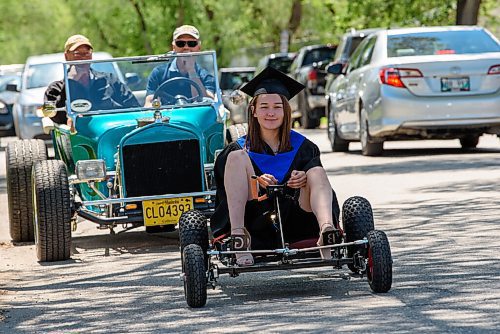 JESSE BOILY  / WINNIPEG FREE PRESS
Gianna Donnelly, built her go-kart as a school project and hopes to go into the welding program at Red River College, stops for a photo at the Seven Oaks Met schools graduation on Friday. The school put together a special drive thru for it 27 graduates. Families drove up in  two cars to celebrate their graduates. Graduates then walked up on stage in front of their families and moved their own tassels for social distancing purposes.  Friday, June 19, 2020.
Reporter: