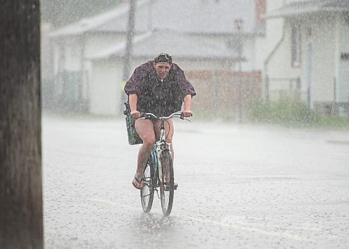 Mike Sudoma / Winnipeg Free Press
A woman bikes down Ellice Ave through Saturday afternoons downpour
June 20, 2020