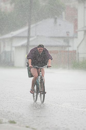 Mike Sudoma / Winnipeg Free Press
A woman bikes down Ellice Ave through Saturday afternoons downpour
June 20, 2020