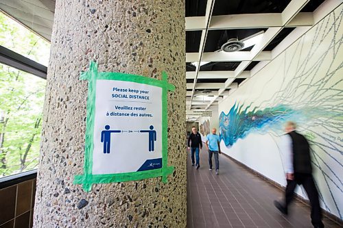 MIKAELA MACKENZIE / WINNIPEG FREE PRESS

A physical distancing poster in the skywalk above the Millennium Library in Winnipeg on Monday, June 22, 2020.  For Melissa story.
Winnipeg Free Press 2020.