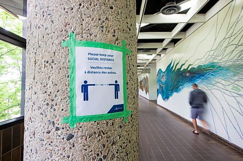 MIKAELA MACKENZIE / WINNIPEG FREE PRESS

A physical distancing poster in the skywalk above the Millennium Library in Winnipeg on Monday, June 22, 2020.  For Melissa story.
Winnipeg Free Press 2020.