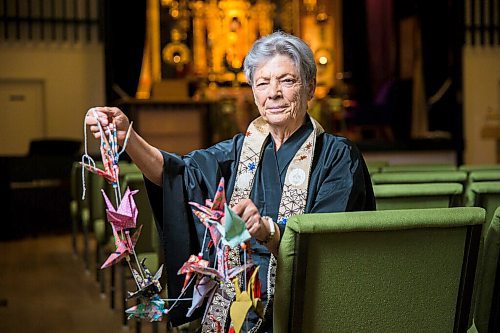 MIKAELA MACKENZIE / WINNIPEG FREE PRESS

Sensei Tanis Moore of the Manitoba Buddhist Temple poses for a portrait with some paper cranes in Winnipeg on Tuesday, June 23, 2020. The temple is making 1,000 origami paper cranes as symbols of hope and inviting other Winnipeggers to join them in the project. For John Longhurst story.
Winnipeg Free Press 2020.
