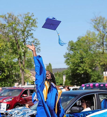 RUTH BONNEVILLE / WINNIPEG FREE PRESS

LOCAL - Drive-In Graduation at St. Maurice High School, 1639 Pembina Highway.

Photo of Valedictorian, Miss Nyume Mahmoud as she throws up her grad cap into the air after grad ceremony Wednesday.  

Graduating students at  St. Maurice High School attend an outdoor graduation ceremony in their school parking lot with their fellow students with social distancing measures in place on Wednesday.  Students sat in seats set apart while their families stayed in their vehicles behind them.  

See Gabby's story. 

.June 24,  2020
