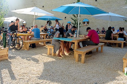 JESSE BOILY  / WINNIPEG FREE PRESS
Patrons relax in the shade on the patio at the Beer Can on Wednesday. The Beer Can is a patio spot where many Winnipegers are going to enjoy the summer and a drink. Wednesday, June 24, 2020.
Reporter: Melissa Martin
