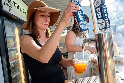 JESSE BOILY  / WINNIPEG FREE PRESS
Amber Nielsen pours a beer at the Beer Can on Wednesday. The Beer Can is a patio spot where many Winnipegers are going to enjoy the summer and a drink. Wednesday, June 24, 2020.
Reporter: Melissa Martin
