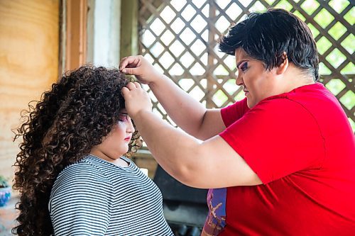 MIKAELA MACKENZIE / WINNIPEG FREE PRESS

Guncle Smokey Trixx Starr fixes Olivia Limeheart's wig before posing for portraits on their porch in Winnipeg on Thursday, June 25, 2020. The two are stars of Synonym Art Consultation's drag safe grad video. For Eva Wasney story. 
Winnipeg Free Press 2020.