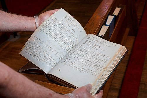 MIKE DEAL / WINNIPEG FREE PRESS
Terry Moore with a record book dating from 1860-1903 at St. John's Anglican Cathedral, 135 Anderson Ave.
St. John's Cathedral was poised to celebrated 200 years in 2020, but all big celebrations are cancelled. Instead, parishioner Terry Moore has researched and written more than 100 little stories about the church's history in establishing the Anglican church in Western Canada.
200625 - Thursday, June 25, 2020.