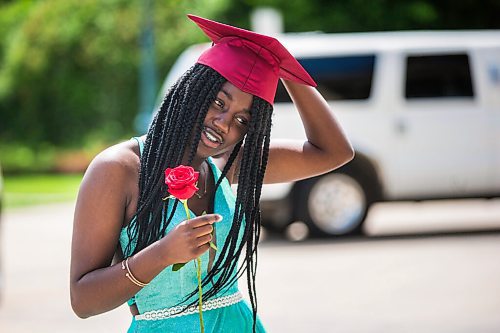 MIKAELA MACKENZIE / WINNIPEG FREE PRESS

Daniel McIntyre Collegiate Institute grad Jayden Cameron adjusts her cap after having professional photos taken with a limo for free at the Manitoba Legislative Building in Winnipeg on Thursday, June 25, 2020. 
Winnipeg Free Press 2020.