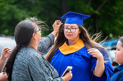 MIKAELA MACKENZIE / WINNIPEG FREE PRESS

Clara Fontaine, St. James Collegiate grad, gets her cap adjusted by her mom, Denise Linklater, before getting professional photos taken with a limo for free at the Manitoba Legislative Building in Winnipeg on Thursday, June 25, 2020. 
Winnipeg Free Press 2020.