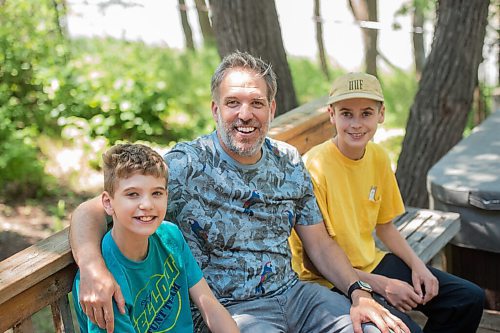 Mike Sudoma / Winnipeg Free Press
 Winnipeg Folk Festival Associate Director, Chris Frayer and his two sons Ivan (left) and Isaac (right) hang out in their backyard Friday afternoon
June 26, 2020