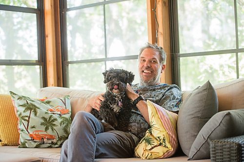 Mike Sudoma / Winnipeg Free Press
Chris Frayer, Associate Director of the Winnipeg Folk Festival sits with his pup, Izzy in their sun room which Chris refers to as The California Room Friday afternoon
June 26, 2020