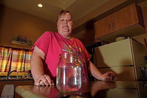 JESSE BOILY  / WINNIPEG FREE PRESS
Leslie Carey shows the smelly water at her home after construction outside of it has caused flooding in her basement and smelly water on Friday. The bad smelling water has caused her to need to get bottled water to drink and clean with, as she cant do dishes, laundery or shower with the current tap water.  Friday, June 26, 2020.
Reporter: Gabby