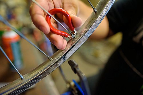 JESSE BOILY  / WINNIPEG FREE PRESS
Aaron Maciejko, who is a volunteer at Orioles Bike Cage, a community bicycle shop that helps people repair and maintain their bicycles, works on a bicycle on Friday. Friday, June 26, 2020.
Reporter: Aaron Epp