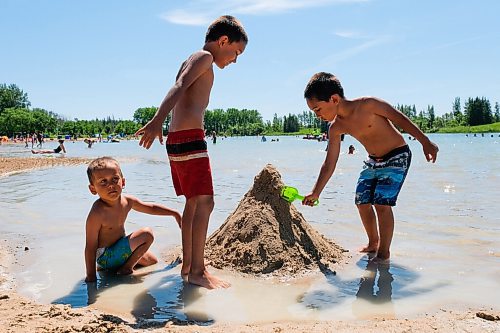 Daniel Crump / Winnipeg Free Press. (From left) Brothers Nathanael, James and Aaron Fullerton build a sand castle on the beach at Birds Hill Park. Temperatures in the low 30s brought many people to the beach. June 27, 2020.