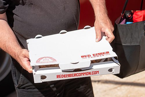 Mike Sudoma / Winnipeg Free Press
A customer boxes up their freshly made pizza from the Red Ember at the St Norbert Farmers Market Saturday morning
June 27, 2020
