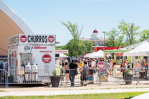Mike Sudoma / Winnipeg Free Press
Shoppers at the St Norbert Farmers Market hangout beside the Churro Stop food truck Saturday morning
June 27, 2020