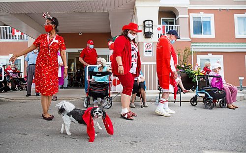 MIKE DEAL / WINNIPEG FREE PRESS
The All Seniors Care Living Centre at 50 Ridgecrest Avenue held at Pre-Canada Day celebration Tuesday afternoon, which included a Superhero Pet Companion Parade where some of the residences and their pets showed off their best superhero disguises.
Lifestyle Director, Renee Kelly, with Candy one of the residences pet dog during the parade.
200630 - Tuesday, June 30, 2020.