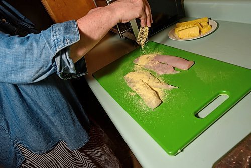 JESSE BOILY  / WINNIPEG FREE PRESS
Alison Gillmor prepares her pickerel dinner kit from Fusion Grill on Wednesday. Wednesday, July 1, 2020.
Reporter:Alison Gillmor