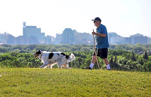 RUTH BONNEVILLE / WINNIPEG FREE PRESS

Local - Standup photo 

Roger York takes his 11-year-old dog,  Geordie, a Border Collie - Great pyrenees cross, for a walk at  Garbage Hill / Westview Park, Thursday morning.  

The duo walk every morning along the crest of the hill with a great view of downtown Winnipeg in all weather but have been going earlier in the day due to the hot Wpg.  weather.

July 2nd,,  2020