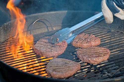 Daniel Crump / Winnipeg Free Press. Grilling the meal kit burgers on an outdoor barbecue. July 4, 2020.