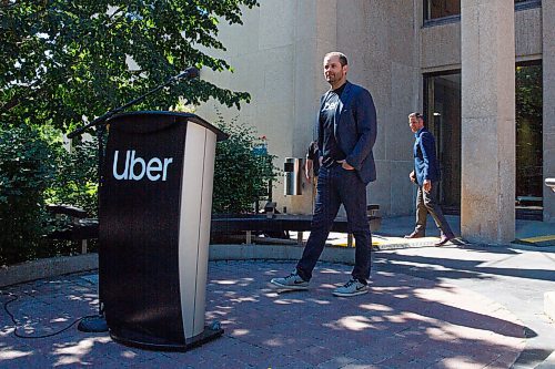 MIKE DEAL / WINNIPEG FREE PRESS
Michael van Hemman, Head of City Operations for Uber in Canada heads to the podium during the announcement at City Hall that the ride sharing service is open for business in Winnipeg as of today. 
200707 - Tuesday, July 07, 2020.