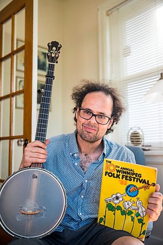 MIKAELA MACKENZIE / WINNIPEG FREE PRESS

Leonard Podolak, son of Folk Fest founder Mitch Podolak, poses for a portrait with a 1983 program in his house in Winnipeg on Wednesday, July 8, 2020. For Al Small story.
Winnipeg Free Press 2020.