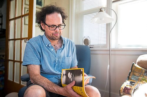 MIKAELA MACKENZIE / WINNIPEG FREE PRESS

Leonard Podolak, son of Folk Fest founder Mitch Podolak, poses for a portrait with a 1983 program in his house in Winnipeg on Wednesday, July 8, 2020. For Al Small story.
Winnipeg Free Press 2020.