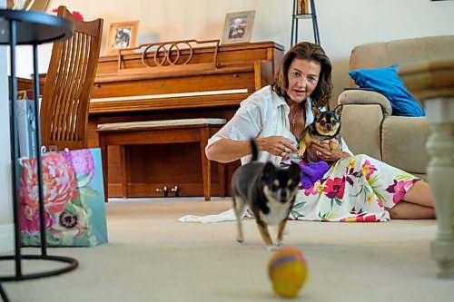JESSE BOILY  / WINNIPEG FREE PRESS
Carla Martinelli-Irvine, the founder and executive director of Winnipeg Pet Rescue Shelter, recently completed her radiation treatment for her breast cancer, plays with her dogs, Chica and JoJo in her home on Thursday. She cannot currently go into the shelter but calls the shelter 2-3 times a day. Thursday, July 9, 2020.
Reporter: Doug
