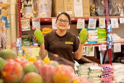 Mike Sudoma / Winnipeg Free Press
Linda Eng, the store manager of Youngs Market on William holds up some Vietnamese mangoes Friday afternoon. These mangoes are a popular ingredient in salads because of their sweet, and crunchy nature.
July 10, 2020