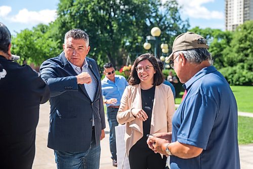 MIKAELA MACKENZIE / WINNIPEG FREE PRESS

James Bezan, Conservative member of parliament for Selkirk-Interlake-Eastman (left) and Niki Ashton, NDP member of parliament for Churchill-Keewatinook Aski, elbow-bump commercial fishers and community representatives before speaking to the media about the lack of support from the federal government for Manitobas commercial fishers at the Manitoba Legislative Building in Winnipeg on Friday, July 10, 2020. For Dillon/Gabrielle? story.
Winnipeg Free Press 2020.