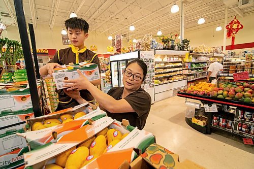 Mike Sudoma / Winnipeg Free Press

Store Manager, Linda Eng, and her nephew, Wesley Lim, unload a large shipment of mangoes at Youngs Market on William Ave Friday afternoon.

July 10, 2020
