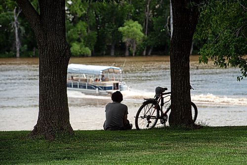 Mike Sudoma / Winnipeg Free Press
A cyclist looks out at a river boat driving along the Red River Friday afternoon at the Forks
July 10, 2020