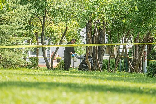 Mike Sudoma / Winnipeg Free Press
Winnipeg Police Services Tactical Team places an unknown item into a clear plastic bag in Montrose park Saturday afternoon 
July 11, 2020