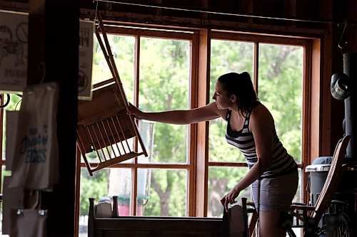 SHANNON VANRAES / WINNIPEG FREE PRESS
Amber Hiebert adjusts an artifact in the window of the Mennonite Heritage Village's General store in Steinbach on July 12, 2020.