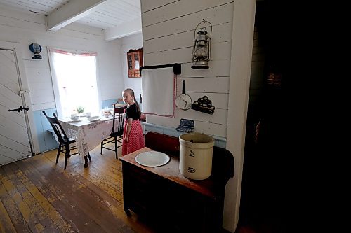 SHANNON VANRAES / WINNIPEG FREE PRESS
Linda Wiebe peers around a corner in a heritage house at the Mennonite Heritage Village in Steinbach on July 12, 2020.