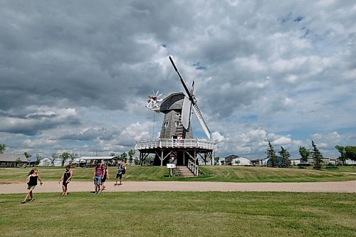 SHANNON VANRAES / WINNIPEG FREE PRESS
Visitors to the Mennonite Heritage Village in Steinbach walk past a replica Dutch windmill on July 12, 2020.