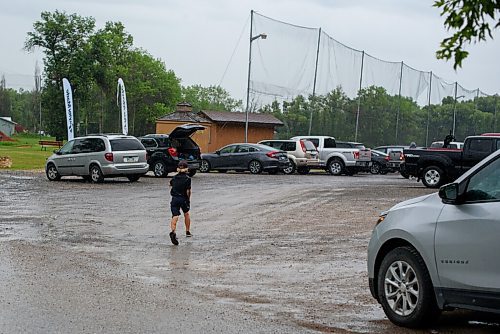JESSE BOILY  / WINNIPEG FREE PRESS
A boy runs to his vehicle as a rain storm caused a pause in play at the Golf Manitobas Mens and Womens Junior Championship at the Selkirk Golf and Country Club on Monday. Monday, July 13, 2020.
Reporter: Mike Sawatzky