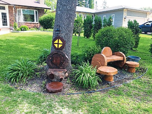 Canstar Community News This wooden bench (at right) and hobbit house were created by Blaine and Sherri Paulson.