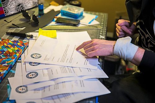 MIKAELA MACKENZIE / WINNIPEG FREE PRESS

JD Renaud flips through prank Duinness World Record prank letters, one of the five things that are getting him through this pandemic, in his home in Winnipeg on Wednesday, July 15, 2020. 
Winnipeg Free Press 2020.