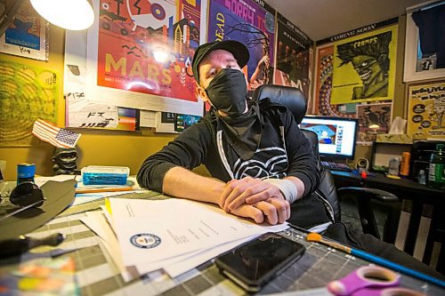 MIKAELA MACKENZIE / WINNIPEG FREE PRESS

JD Renaud poses for a portrait with some of the five things that are getting him through this pandemic (posters and canvases, random letters, and iPod touch) in his home in Winnipeg on Wednesday, July 15, 2020. 
Winnipeg Free Press 2020.