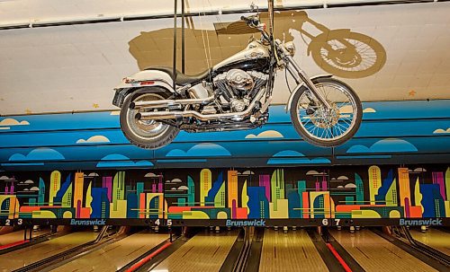 JESSE BOILY  / WINNIPEG FREE PRESS
The motorcycle that sits above the lanes at the Roxy Lanes bowling alley on Wednesday. The couple has owned the bowling alley for 11 years. The building being over 90 years old has become a museum of days past in the building that once was a theatre. The basement is full of artifacts from the past. Wednesday, July 15, 2020.
Reporter: Dave Sanderson