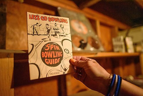 JESSE BOILY  / WINNIPEG FREE PRESS
Melissa Gauthier shows one of the many artifacts in the basement at Roxy Lanes bowling alley on Wednesday. She believes the bowling guide dates back to the 60s. The couple has owned the bowling alley for 11 years. The building being over 90 years old has become a museum of days past in the building that once was a theatre. The basement is full of artifacts from the past. Wednesday, July 15, 2020.
Reporter: Dave Sanderson