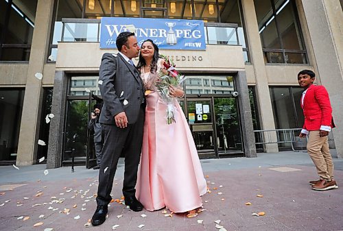 RUTH BONNEVILLE / WINNIPEG FREE PRESS

LOCAL - 1st city hall wedding since COVID 

Ankita and her groom, Harman Ankita share their vows, first kiss and wedding day with close family at City Hall on Friday.  Harman's nephew, Naman Dhruve watches couple as they embrace outside City Hall after their wedding Friday. 

Story: Ankita and Harman (groom) Mavi are the first couple to have their wedding at City Hall since the start of COVID. Reporter talking to the first couple to get married at City Hall since that option closed during the pandemic. 

The short ceremony with close family began at  12 p.m on the Mayors foyer (second floor of city council building) on Friday. 

Gabrielle Piché story.

July 17th, 2020